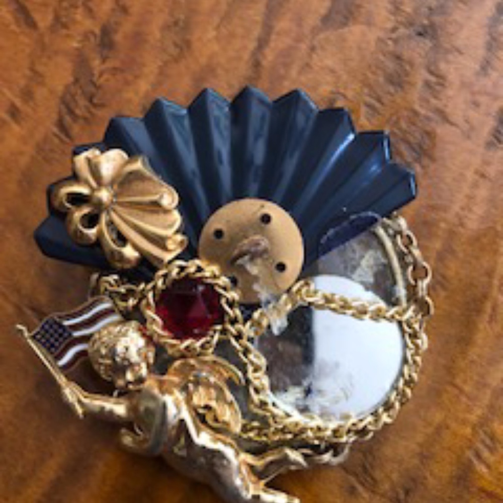 Cherub and mirror brooch
